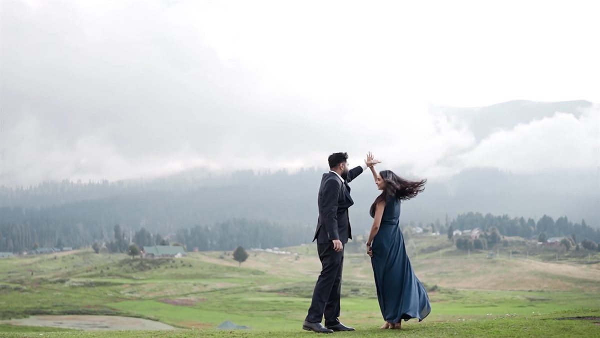 Noor and Vinni dancing in a misty green meadow in Gulmarg, from their pre-wedding film