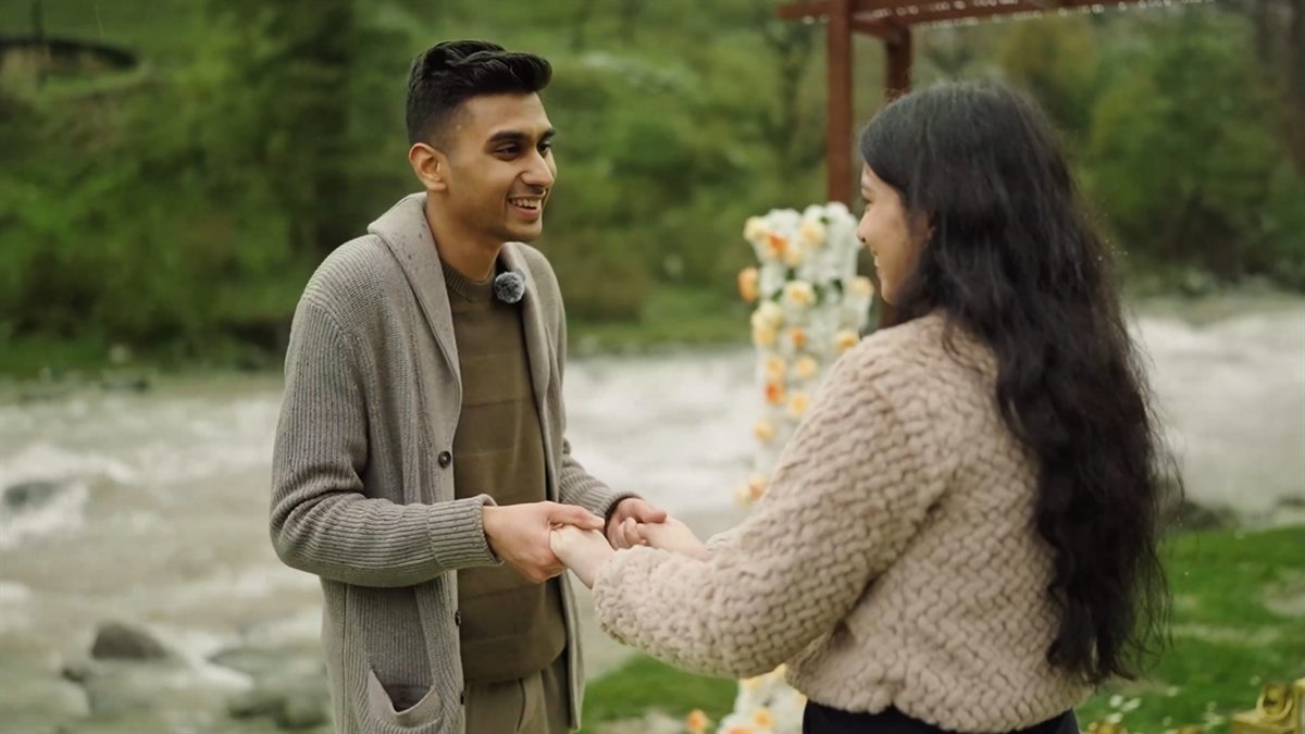 Ritik and Shraddha holding hands beside a mountain stream in Pahalgam, from their pre-wedding film